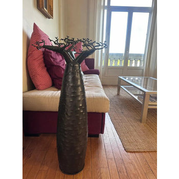 Recycled metal baobab sculpture in a living room � handmade decoration