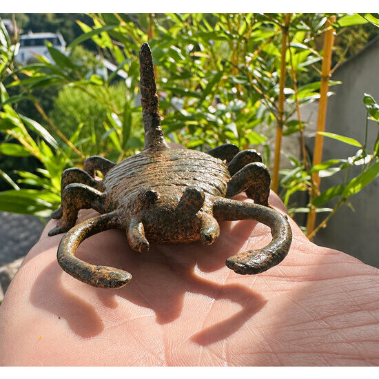 11 cm bronze scorpion figurine resting in a hand